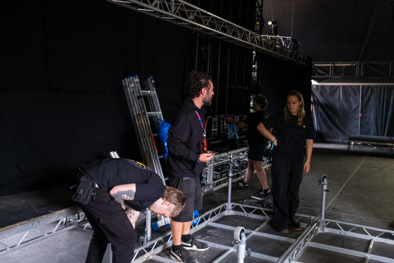 Crew assembling stage infrastructure at We Out Here 2026.